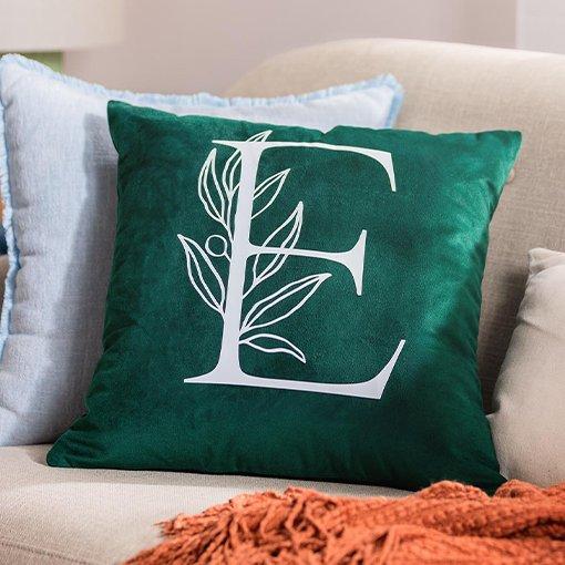 A cushion with a letter E printed on it