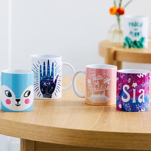 Four mugs with different designs printed on