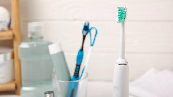 a toothbrush sitting on a counter next to a toothpaste bottle