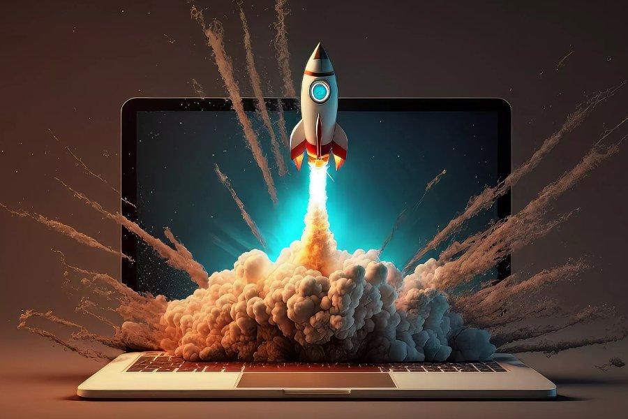 A laptop with a rocket ship blasting out of it 