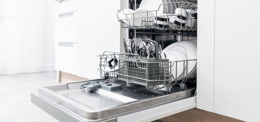 a dishwasher with dishes inside of it in a kitchen