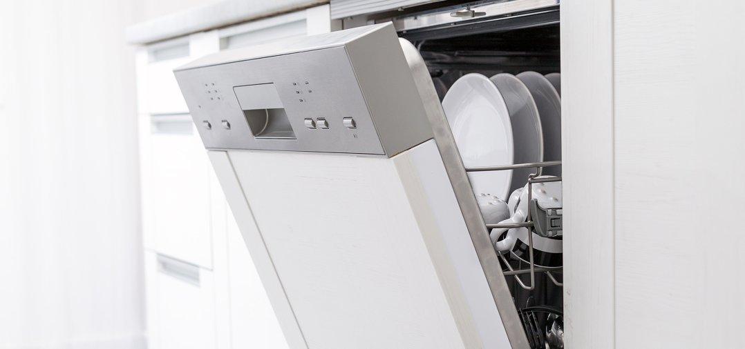 a dishwasher with dishes inside of it in a kitchen