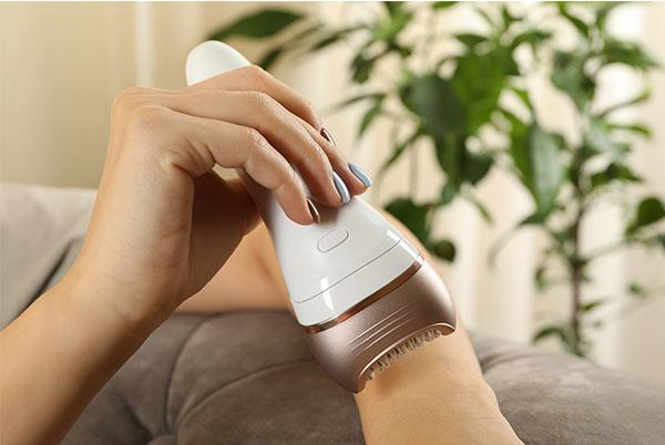 a person using a hair dryer to dry their hair