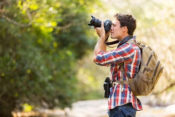 backpacker taking DSLR photos