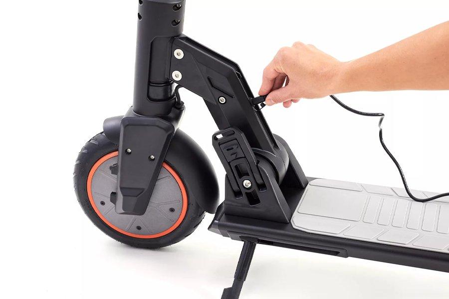 Someone plugging a cable into an electric scooter