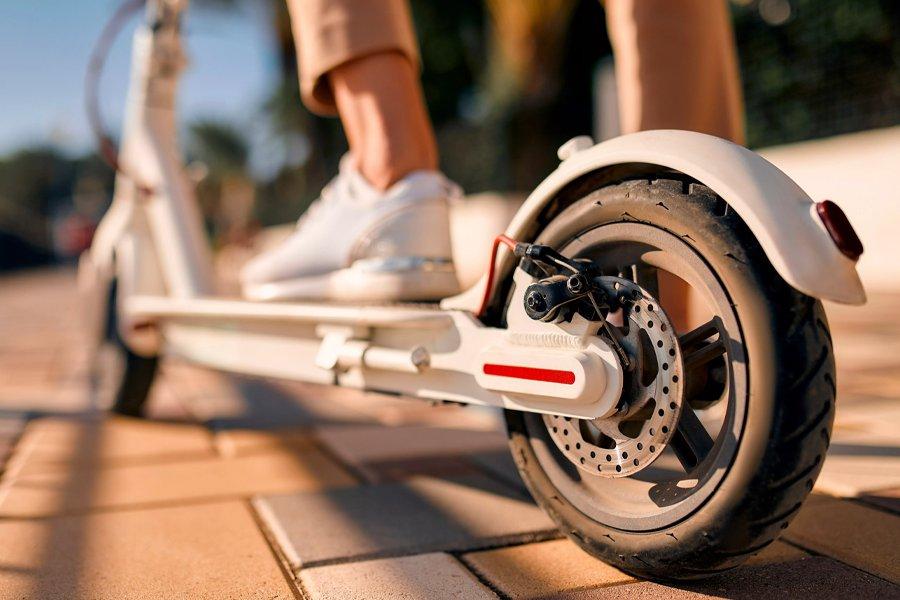 A person standing on a electric scooter