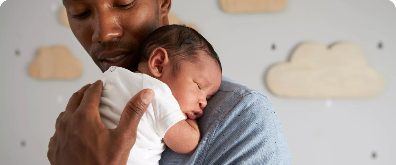 A man holding a newborn baby
