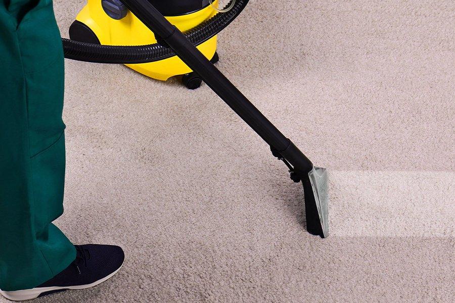 The end of a vacuum cleaner washing carpet