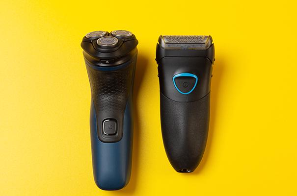 two electric razors on a yellow background