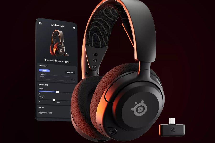 A seat of black over-ear headphones next to a phone with an app on the screen