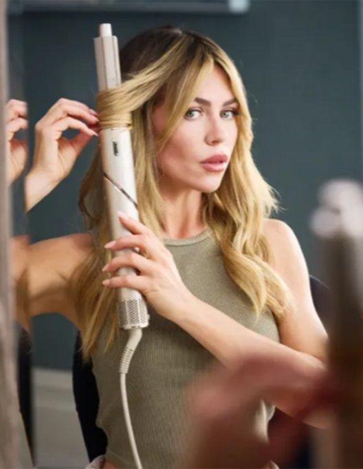 Woman styling her hair with a Shark FlexStyle