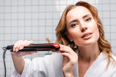 a woman is brushing her hair in front of a mirror