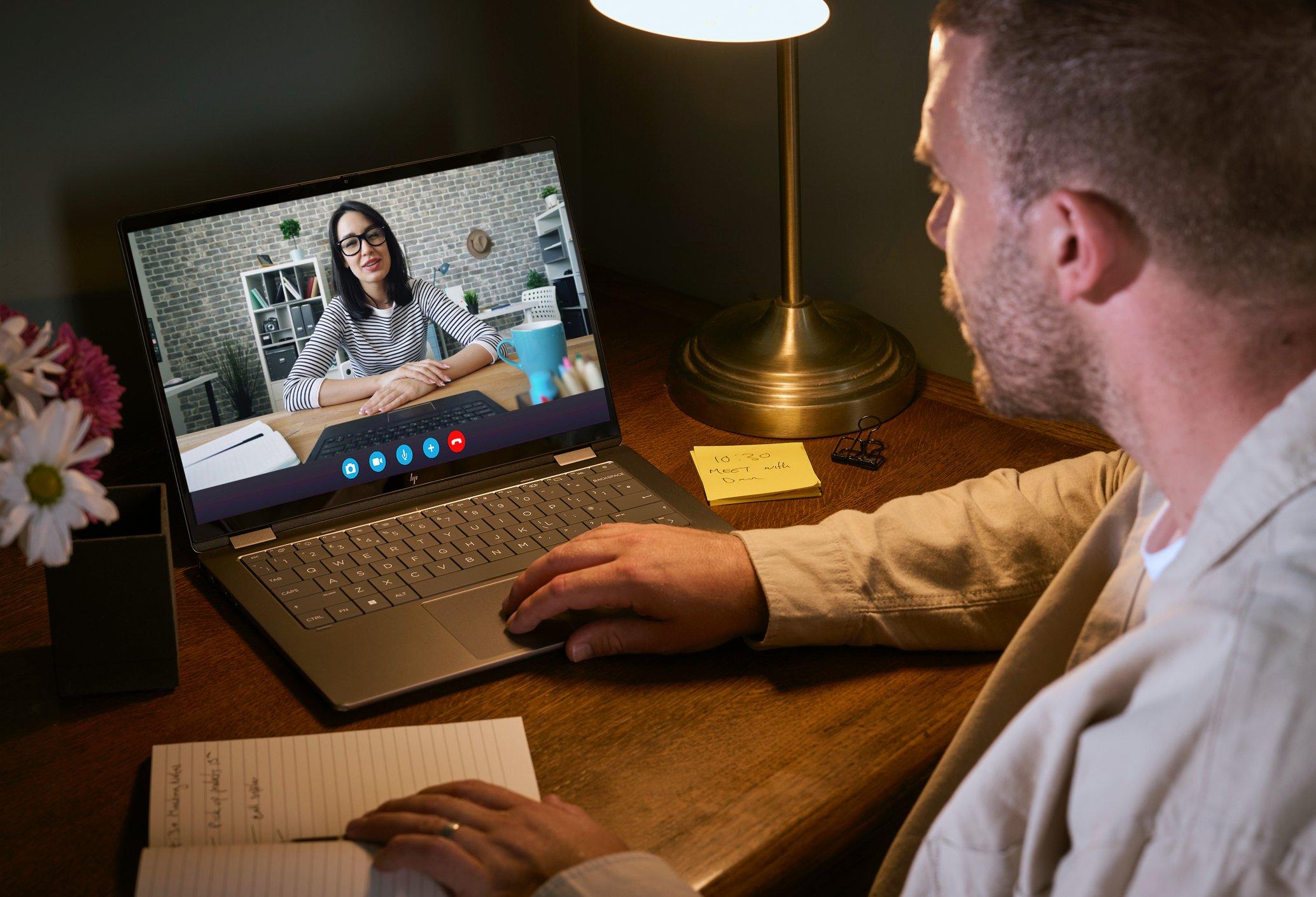 a man laying in bed with laptop on his chest
