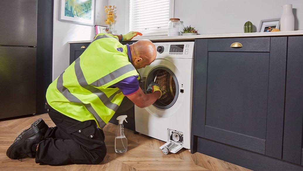 Currys colleague fixing a washing machine