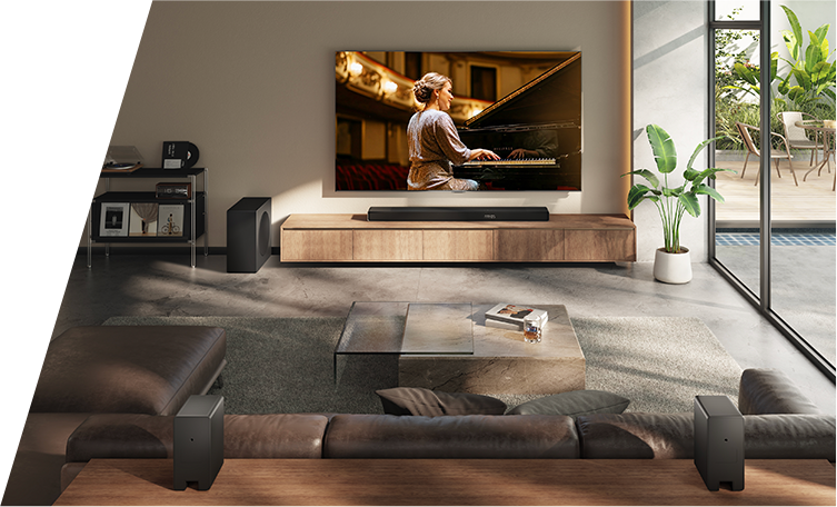 A living room with a TV on the wall showing a woman playing a piano