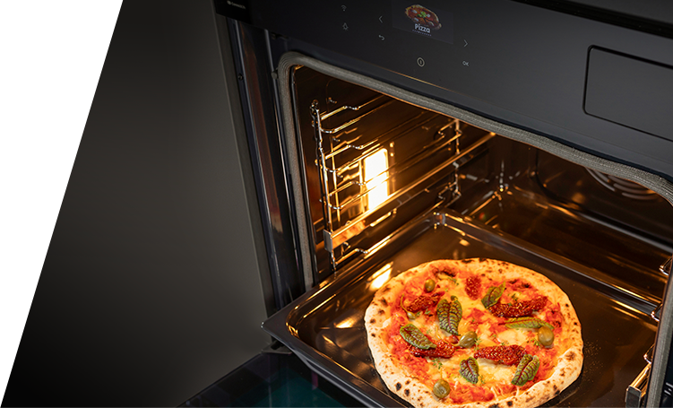 A pizza coming out of an oven