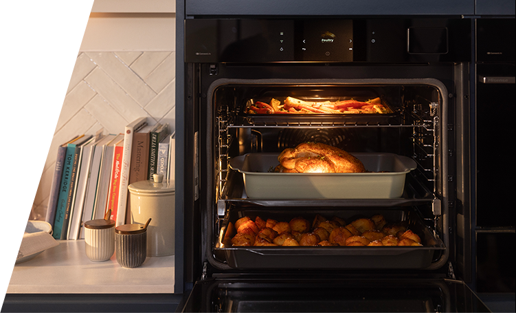 A built-in oven open with three shelves each with food on it