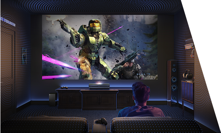 A person watching a large screen being projected from a laser TV