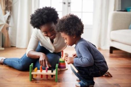 Parent and child playing with toy