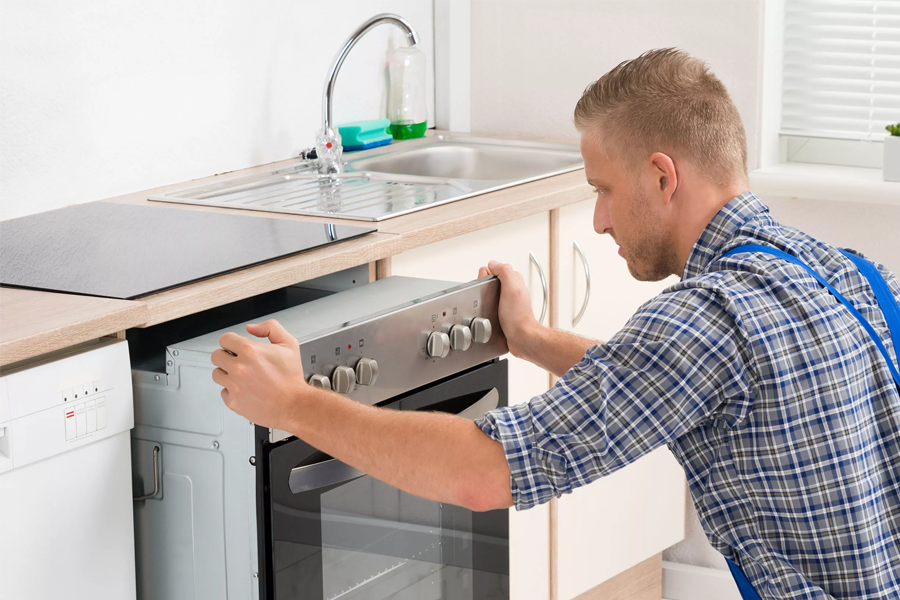 A man installing electric cooker