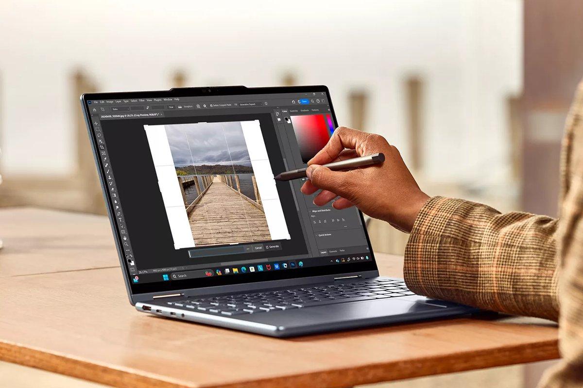 A person draws on a laptop screen with a stylus
