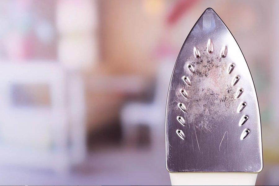 An iron with a dirty plate
