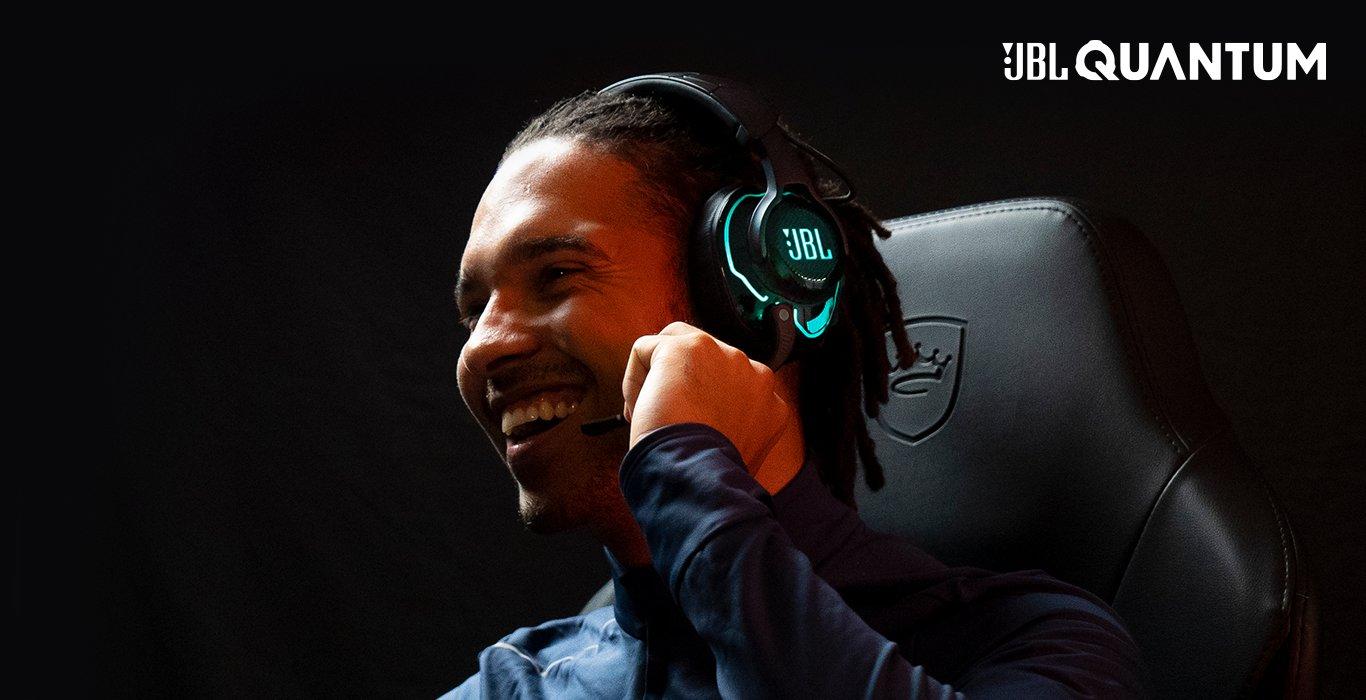 A smiling man wearing a headset