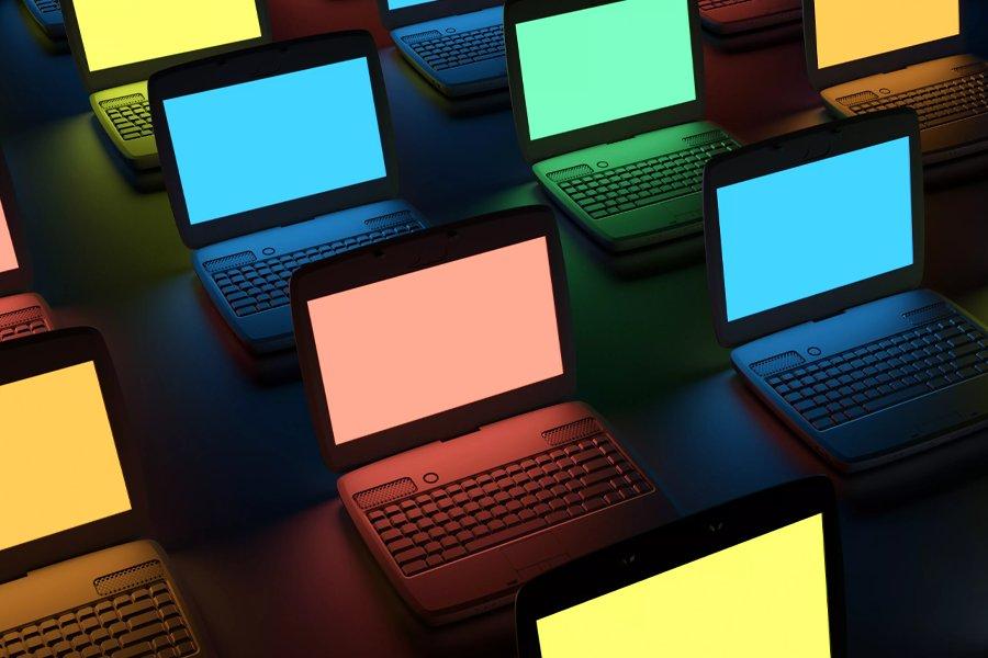 Laptops lined up on a black background