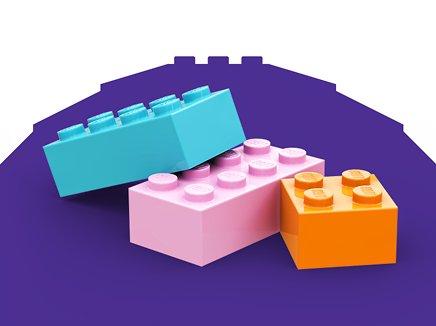 Three LEGO blocks on a purple background