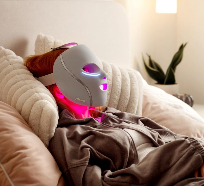 Lady wearing Shark mask in bed