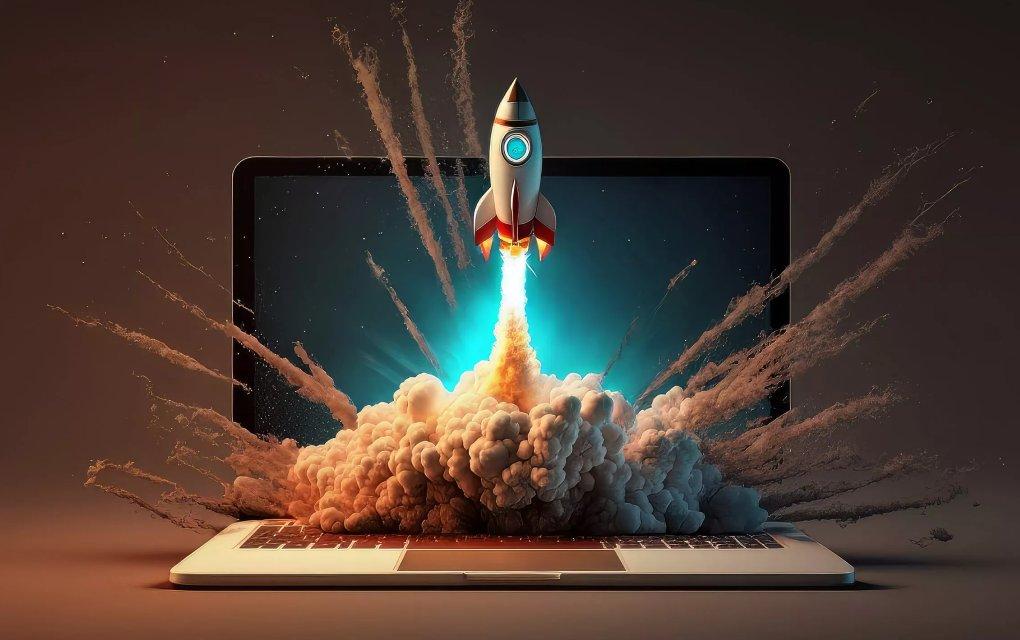 A laptop with a rocket blasting out of the screen