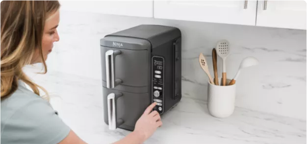 Women operating fryer