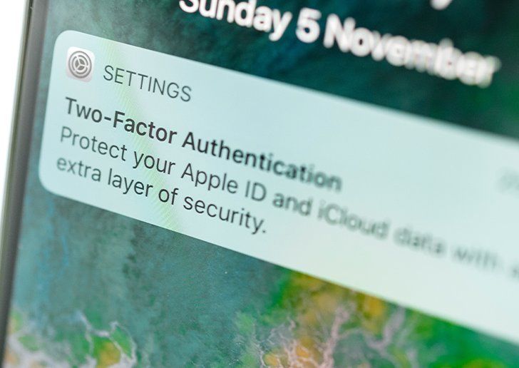 A close up of a mobile phone with a pop up on the screen for two-factor authentication