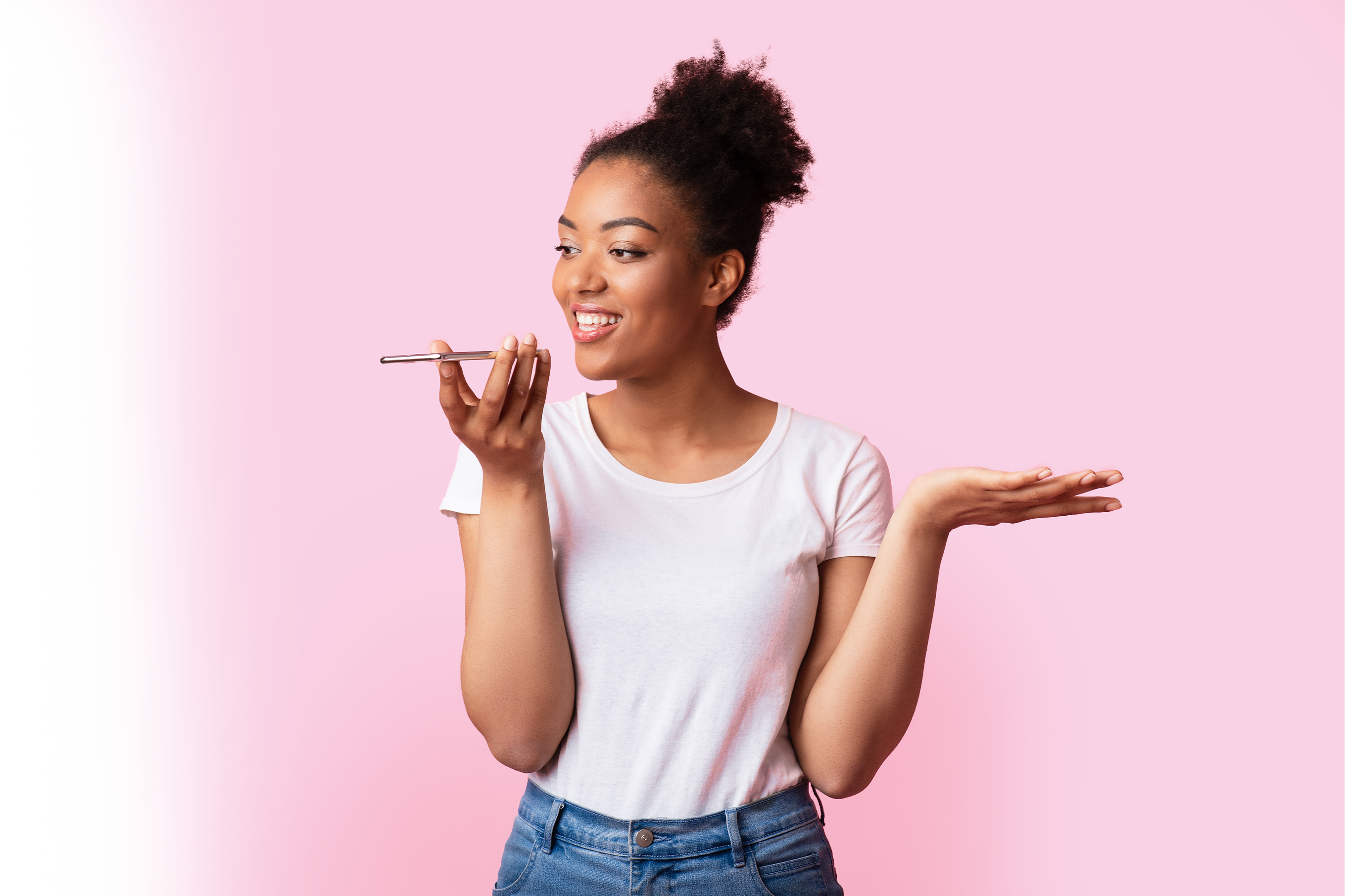 Woman smiling whilst holding a smart phone