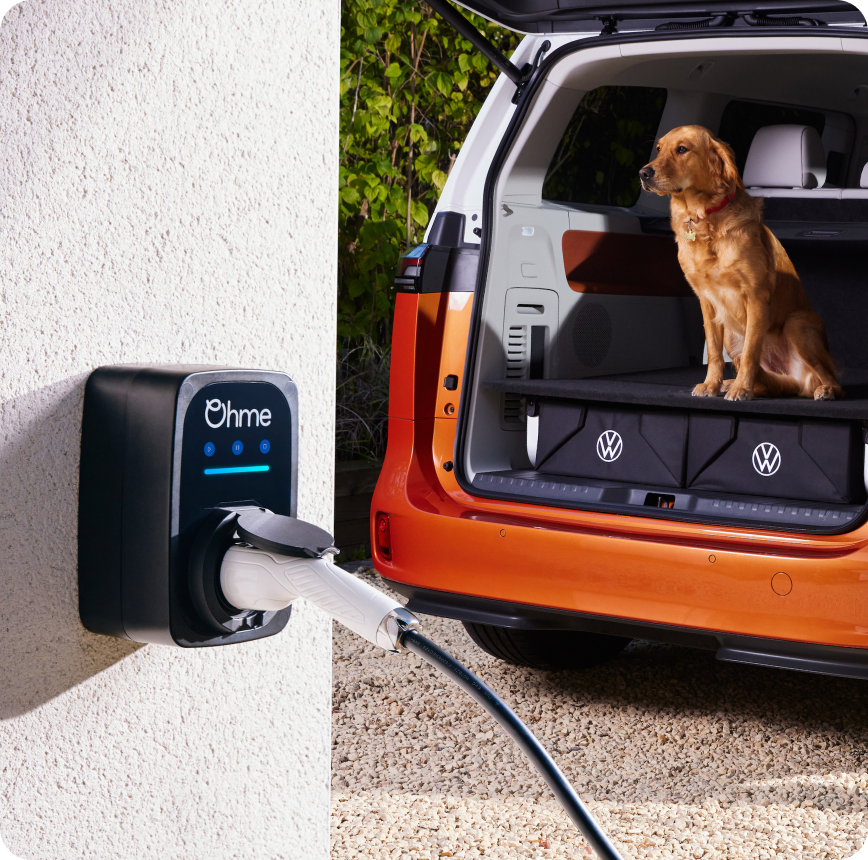 Electric car plugged into Ohme charger on wall