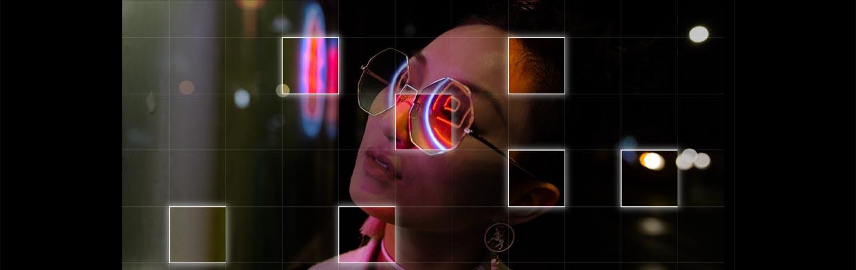 Neon lights reflected in a pair of glasses to illustrate details set the tone