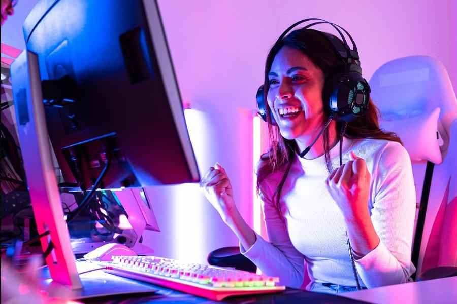 A woman sitting at a PC with a headset on