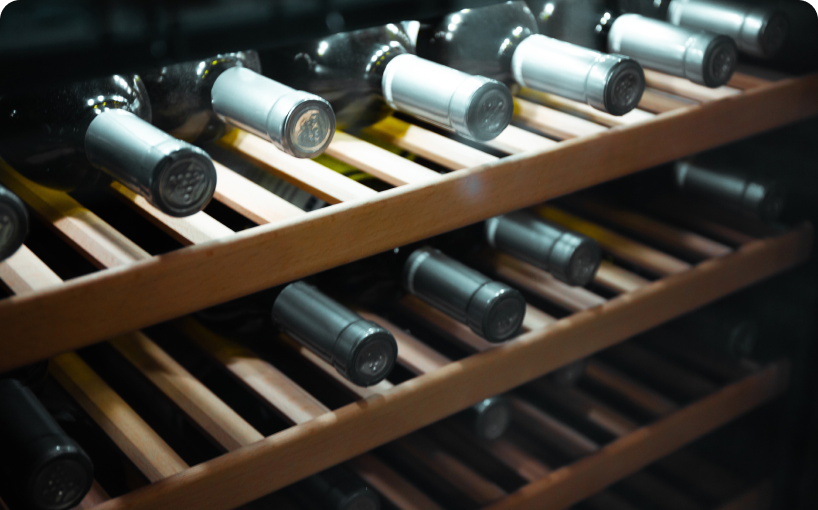 A wine cooler full of wine bottles