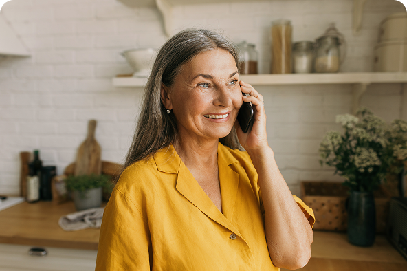 a woman holding a phone to her ear whilst smiling