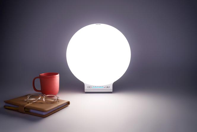 A bright lamp on a desk with a book