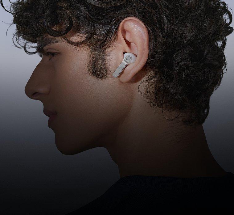 A person in profile wearing a Samsung Galaxy Bud headphone