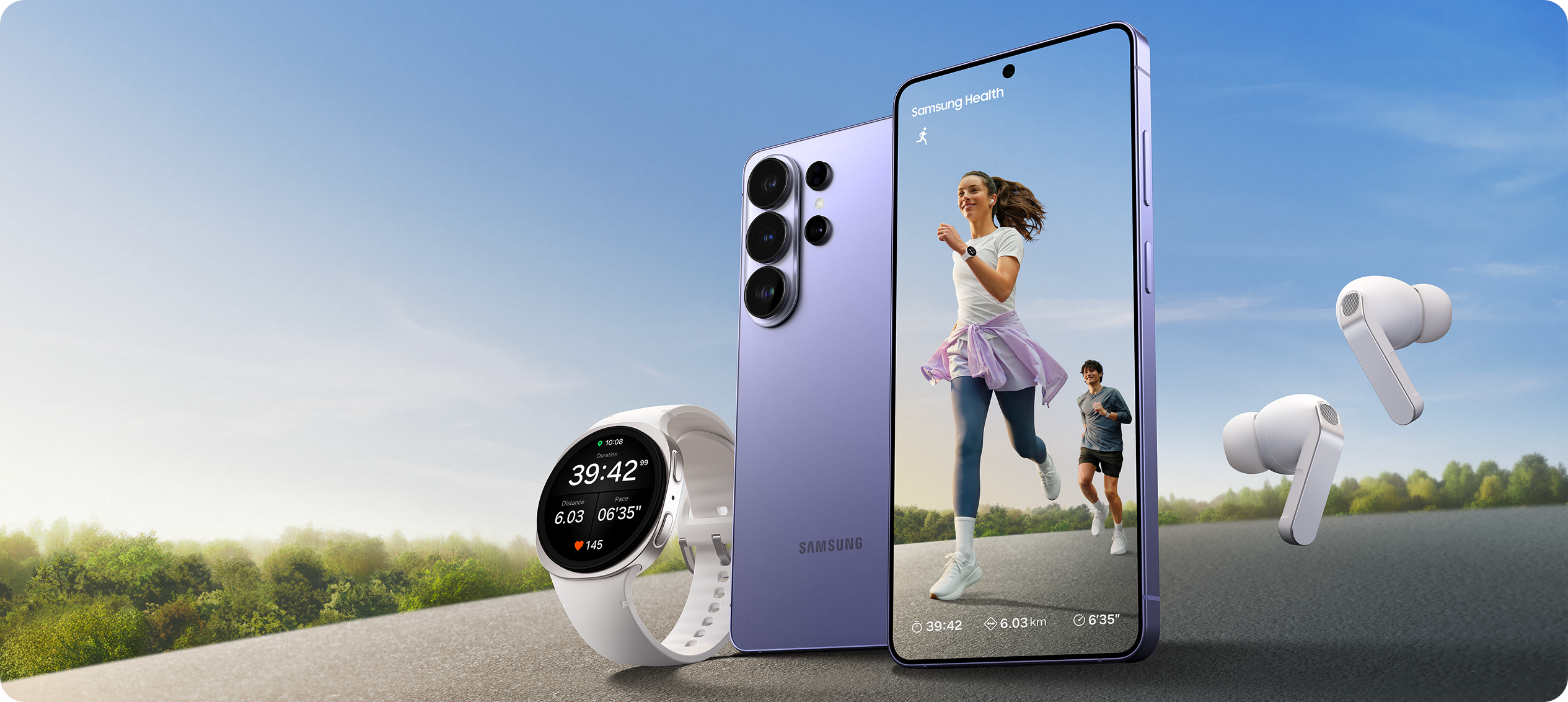 A Samsung Galaxy mobile phone, watch and earbuds on a road