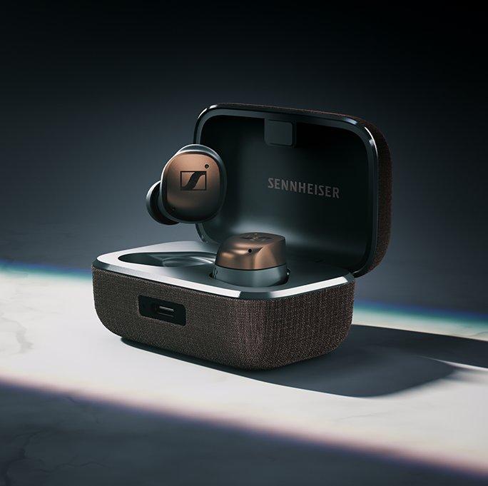 A set of black earbuds in a case with Sennheiser written inside