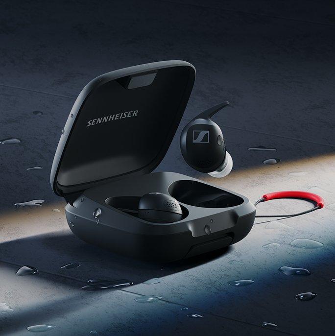 A set of black sports earbuds in a case with Sennheiser written inside