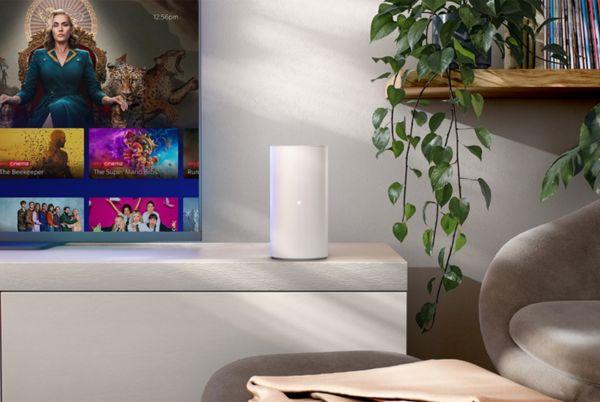 a television with a Sky Broadband router beside it