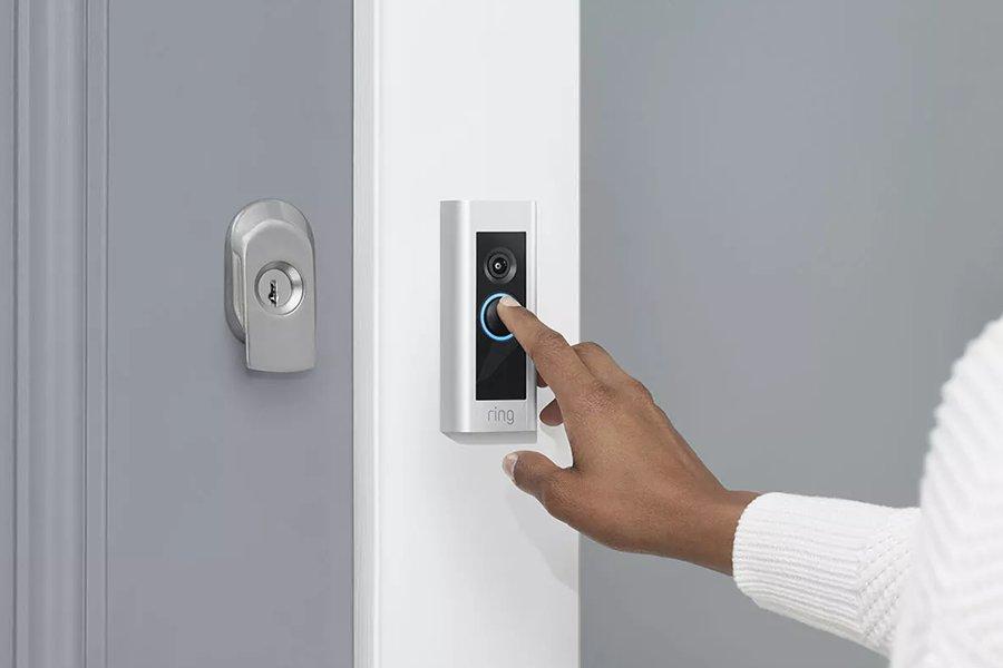 a person ringing a smart doorbell
