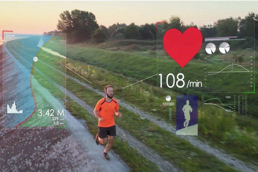 A man running down a track next to some water with graphic showing heart rate etc over the top