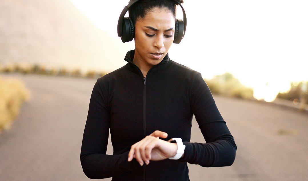 a person is using their smart watch to check the time