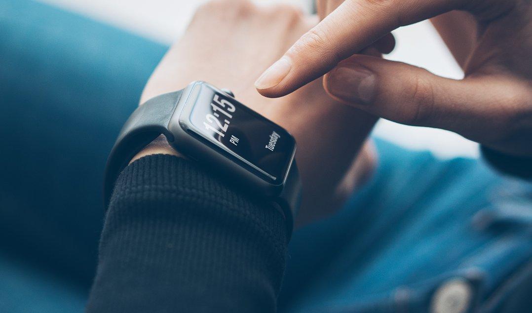 a person is using their smart watch to check the time