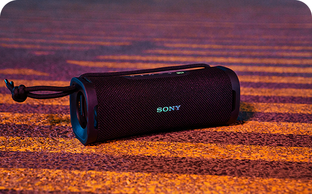A bluetooth speaker on a stripey surface